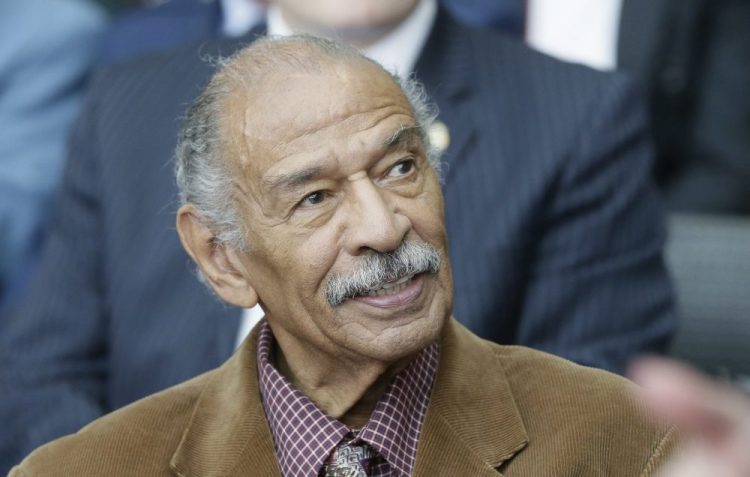 U.S. Rep. John Conyers attends a ceremony for former U.S. Sen. Carl Levin in April 2016 in Detroit. Detroit police say the former congressman died at his home on Sunday. He was 90.