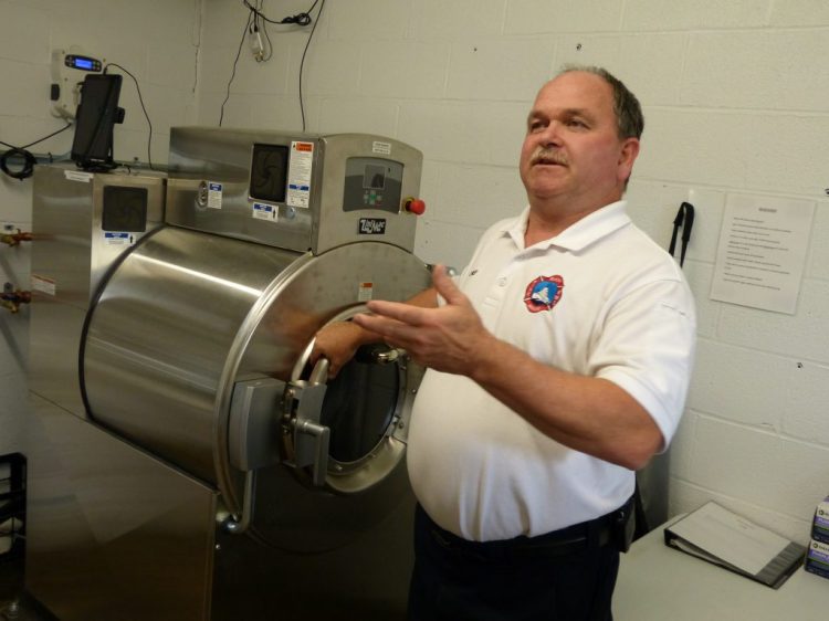 Bath Fire Chief Lawrence Renaud explains how the department’s extractor removes dangerous contaminants from firefighters' gear.