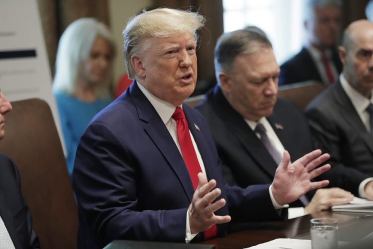 President Trump speaks at Monday's Cabinet meeting at the White House. Secretary of State Mike Pompeo is at right. 