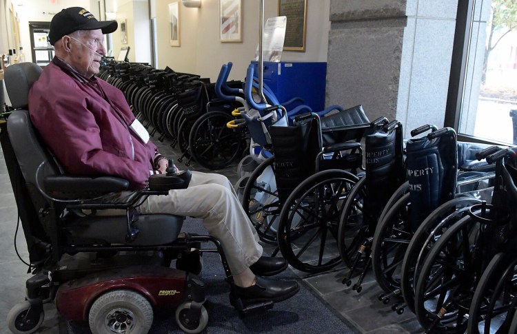 Del Carney watches the Veterans Day observation ceremony Monday from the lobby of the main hospital at Togus VA. Carney, 98, of China, served with the infantry in Europe during World War II.