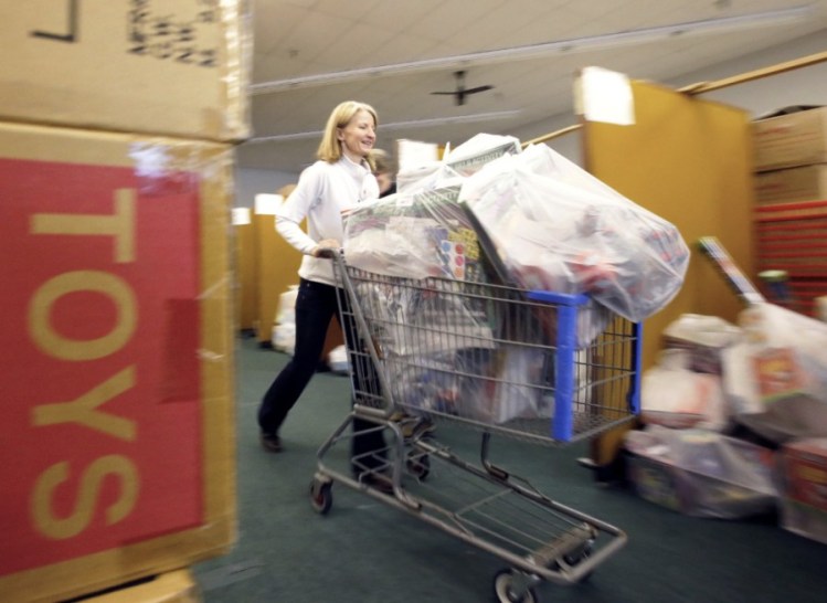 Volunteers with the Press Herald Toy Fund sort and package toys to be distributed to families facing hardships during the holidays.