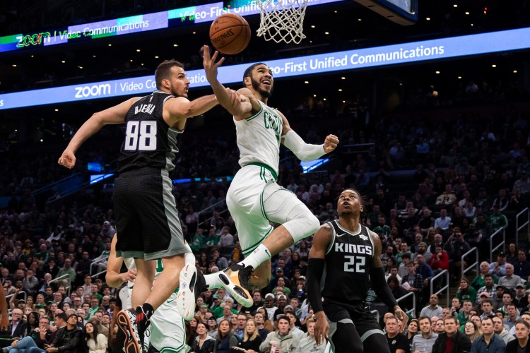 Sacramento's Nemanja Bjelica fouls Boston's Jayson Tatum as he tries to get to the basket during the Celtics' 103-102 win Monday in Boston.