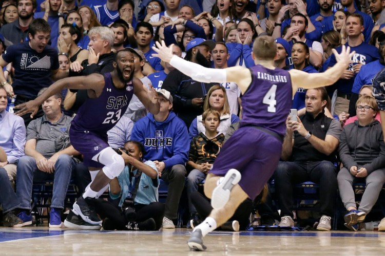 Stephen F. Austin forward Nathan Bain, left, and guard David Kachelries (4) celebrate Bain's game winning basket against Duke in overtime in Durham, N.C. 