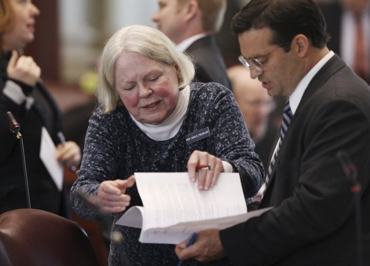 Rep. Ann Peoples, D-Westbrook, left, speaks with then House Majority Leader Seth Berry, D-Bowdoinham, in 2013 at the State House in Augusta.