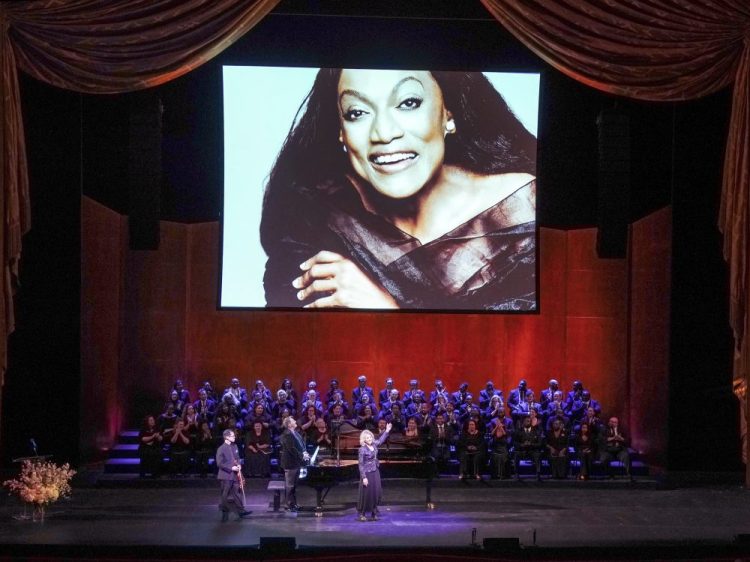 This Nov. 24, 2019 photo released by The Metropolitan Opera shows soprano Renée Fleming, foreground center, violinist David Chan, foreground left, and pianist Gerald Martin Moore during a memorial for Jessye Norman at The Metropolitan Opera in New York.