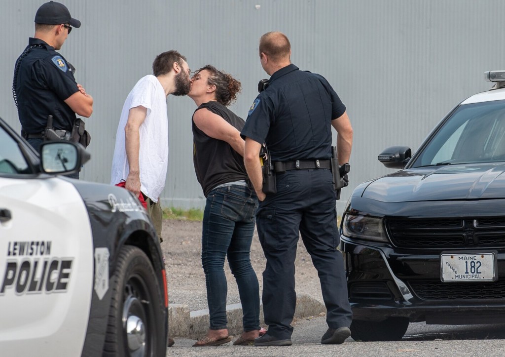 Nicole Simond, 35, of Lewiston, kisses a friend goodbye on Pierce Street in Lewiston on Aug. 7, 2019, after being arrested on a warrant.