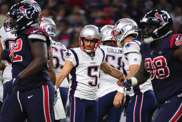 Kia Forbath, center, was able to celebrate after kicking a field goal against Houston Sunday, but he did miss an extra point. He was cut by New England on Tuesday.