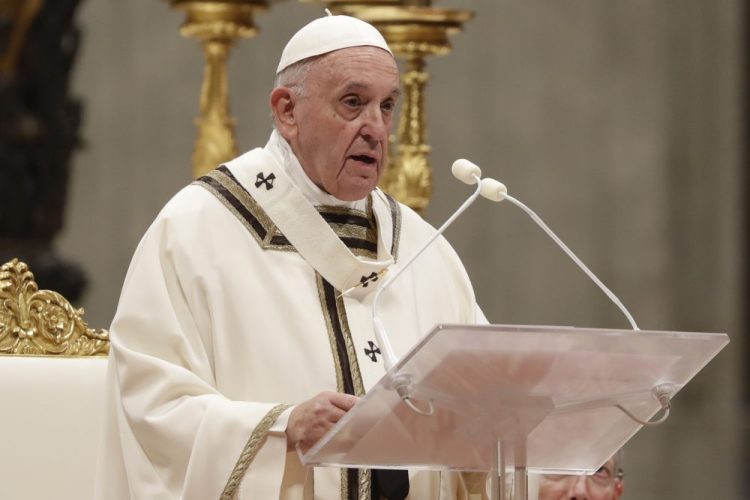 Pope Francis celebrates Christmas Eve Mass in St. Peter's Basilica at the Vatican on Tuesday.