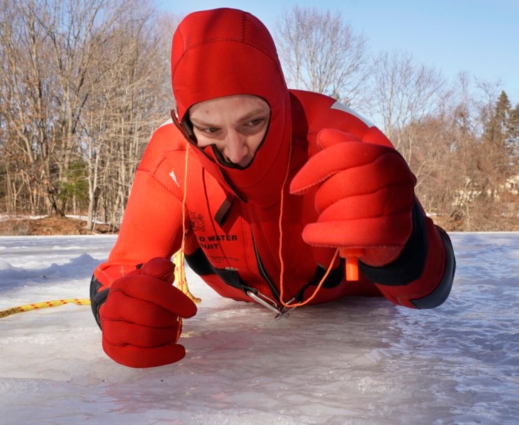 Ben Guild, a firefighter and paramedic with the South Portland Fire Department, demonstrates how to use hand pick to pull oneself back onto ice after falling through a hole. Guild went through the ice on a snowmobile on Rangeley Lake in 2011. 