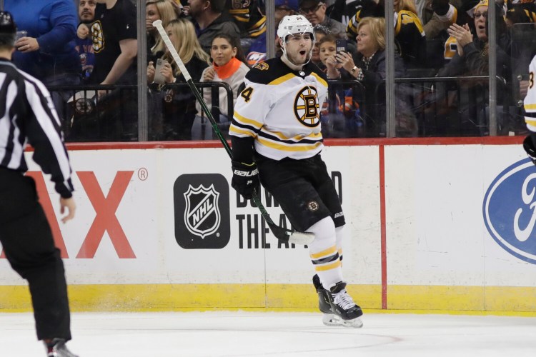 Boston's Jake DeBrusk celebrates after scoring a goal in the second period of Bruins' 3-2 win over the New York Islanders on Saturday in New York.