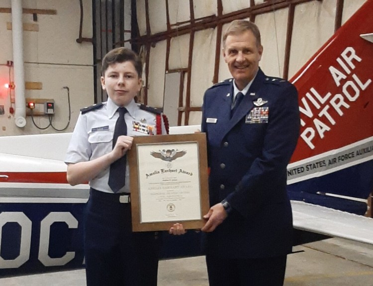 Civil Air Patrol cadet Capt. Andrew Gousse, left, receives
the Amelia Earhart Award, presented by Maj. Gen. Douglas Farnham,
Maine Adjutant General. The presentation was held Thursday night, Jan. 23, at the Augusta-Gardiner Composite Squadron headquarters in Augusta.