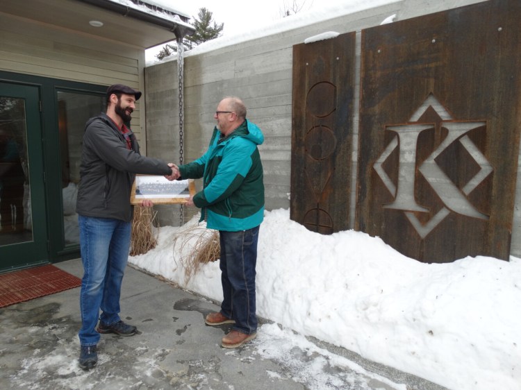 Capital Area Technical Center Building Construction Instructor Tom Holzwarth, right,  presented Greg Buzzell, left, from Knickerbocker Group in Boothbay, a plaque of appreciation for their company donation. The donation was a 2,000 board lot of miscellaneous boards in different widths, lengths and species to be used on various student projects ata the Augusta technical center. The plaque presented is framed with birdseye maple from their generous donation.
