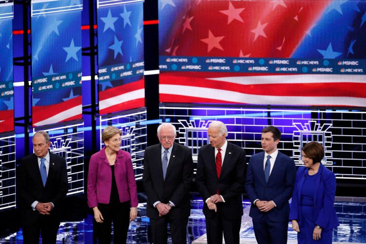 Democratic presidential candidates, from left, former New York City Mayor Michael Bloomberg; Sen. Elizabeth Warren, D-Mass.; Sen. Bernie Sanders, I-Vt.; former Vice President Joe Biden; former South Bend Mayor Pete Buttigieg; and Sen. Amy Klobuchar, D-Minn., stand on stage before a debate Wednesday  in Las Vegas, hosted by NBC News and MSNBC. 

