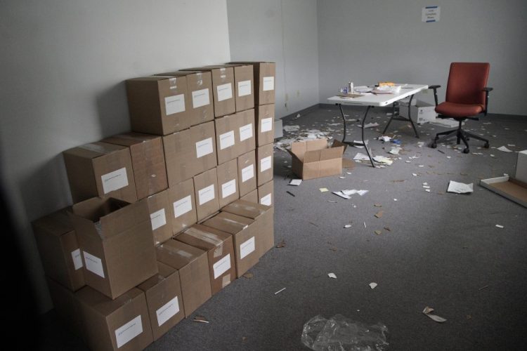 Boxes of voter registration forms are stacked at an unmanned auxiliary office of the Iowa Democratic Party headquarters in Des Moines on Tuesday.