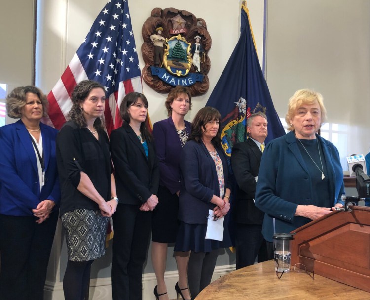 Gov. Janet Mills reviews aspects of her proposed $127 million supplemental budget at the State House in Augusta on Monday.