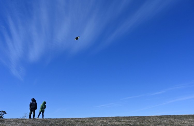 SOUTH PORTLAND, ME - MARCH 16: Brothers Mason 8, and Nolan Poulin 5, of Portland watch as Mason's kite takes flight at Bug Light Park in South Portland Monday, March 16, 2020. The kids were making the most of their free time as schools have been closed due to the coronavirus. (Staff Photo by Shawn Patrick Ouellette/Staff Photographer)