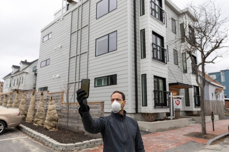Tom Landry, broker and owner of Benchmark Real Estate, starts a Facebook Live video tour of a condo for sale in the East End of Portland on Monday. The coronavirus outbreak has created uncertainty for home sellers, buyers and real estate professionals.