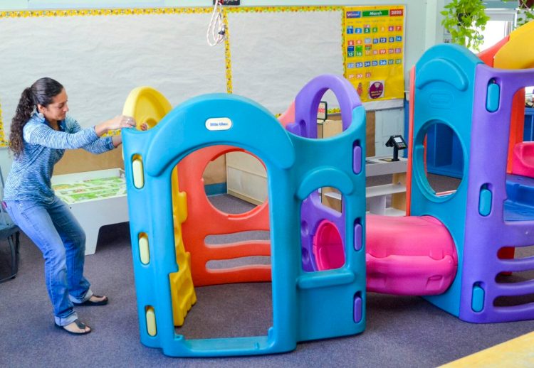 Desiree LeBourdais rearranges the play things in her toddler classroom March 27 at the Boys & Girls Clubs of Kennebec Valley.