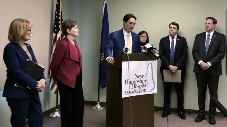 Dr. Benjamin Chan, New Hampshire's state epidemiologist, announces the state's first case of the new COVID-19 virus on Monday in Concord, N.H. Chan was joined at the news conference by members of the state's Congressional delegation, from left: U.S. Sen. Maggie Hassan, U.S. Sen. Jeanne Shaheen, Chan, U.S. Rep. Annie Kuster, U.S. Rep. Chris Pappas, and Gov. Chris Sununu. 