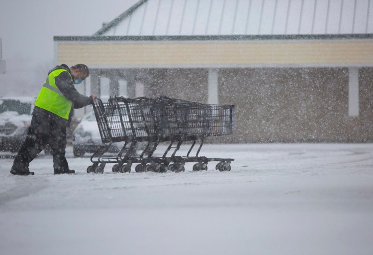 Jason Wigglesworth wears a protective mask as he works at the Shaw’s Supermarket at Westgate Shopping Center in Portland on Thursday.