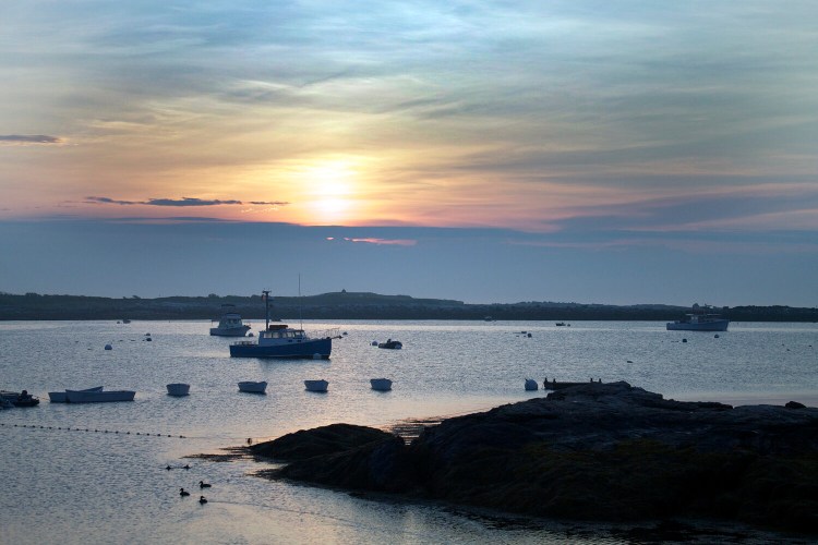 The sun rises over the Isles of Shoals taken from Star Island in Rye, N.H., in June 2013. The police chief of Rye is warning off surfers from its coast while the beaches are closed during the coronavirus pandemic. 