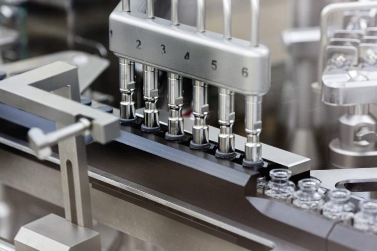 Rubber stoppers are placed onto filled vials of the investigational drug remdesivir at a Gilead manufacturing site in the United States. Given through an IV, the medication is designed to interfere with an enzyme that reproduces viral genetic material. 