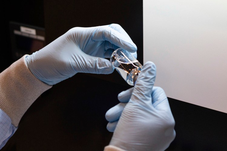 A vial of the drug remdesivir is inspected in March at a Gilead Sciences manufacturing site in the United States. Given through an IV, the medication is designed to interfere with an enzyme that reproduces viral genetic material.