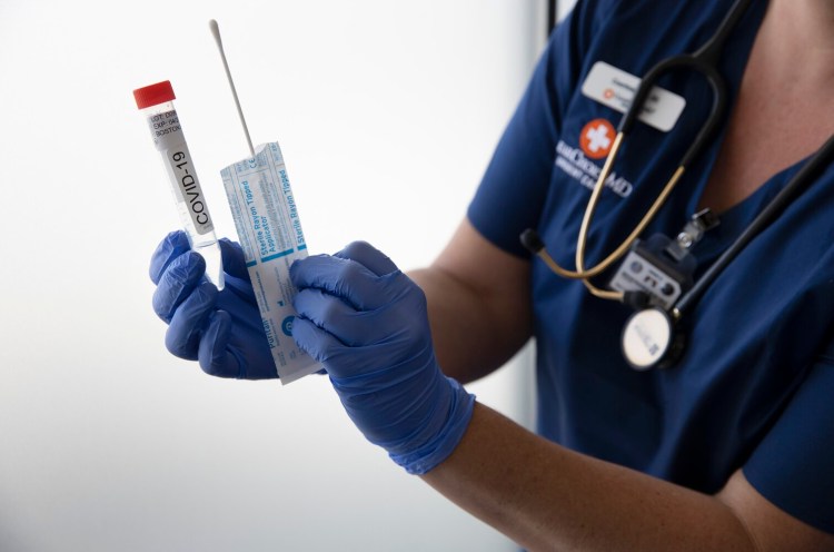 ClearChoiceMD Urgent Care is offering COVID-19 active infection testing and antibody testing. Radiology technician Courtney Bell holds a testing swab and collection tube for the active test. 