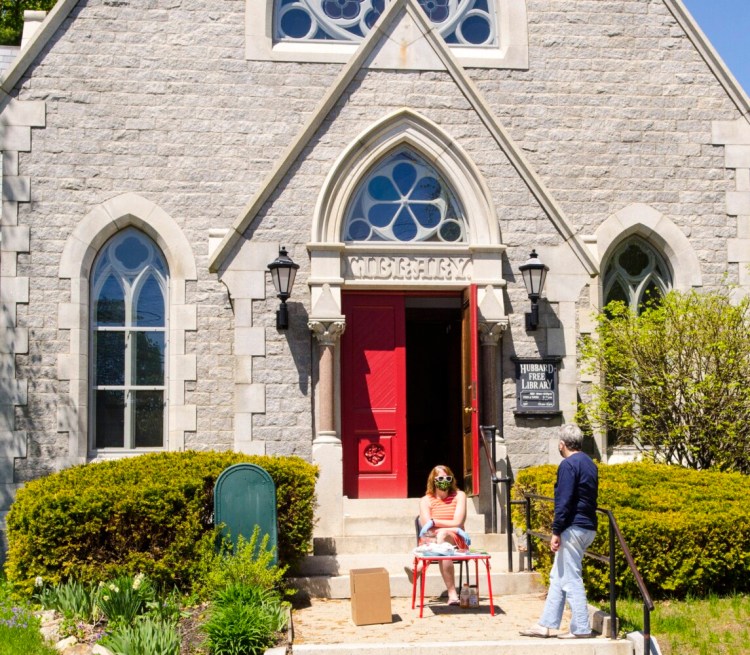 Librarian Doreen Judge, left, chats May 20, 2020, with patron Barbara Rohrbaugh on the front steps of the Hubbard Free Library on Second Street in Hallowell. Starting Friday, the library will be open five days a week.