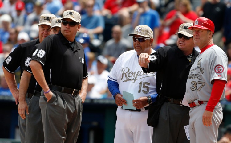 The exchange of lineup cards would be eliminated, fielders will be encourages to space themselves from baserunners between pitches and managers and coaches must wear masks while in the dugouts under Major League Baseball's proposed operations manual for starting the coronavirus-delayed season. 