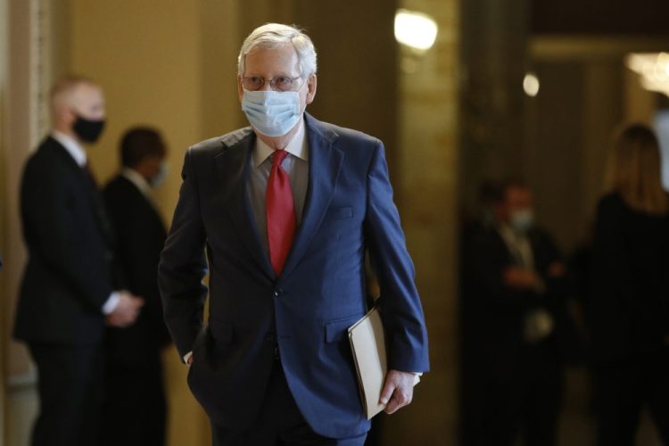 Senate Majority Leader Mitch McConnell walks to the Senate chamber after meeting with Vice President Pence and Treasury Secretary Steve Mnuchin on Tuesday.