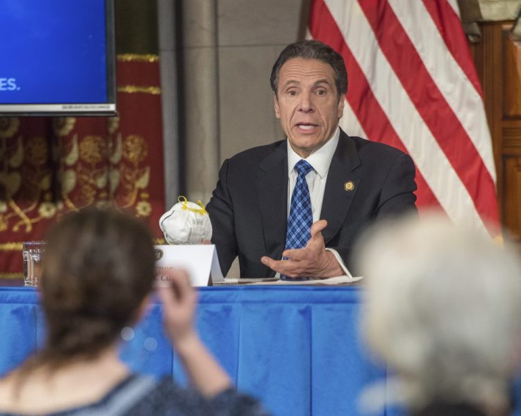 Gov. Andrew Cuomo addresses the media while holding an n95 mask during his daily press briefing on COVID-19 last month in Albany. 