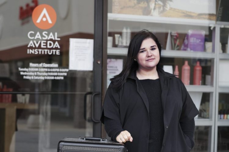 Christa Schall stands outside her cosmetology school, Casal Avedo Institute, in Austintown, Ohio, on May 8. More than 8 million students in the U.S. are enrolled in technical colleges, seeking certification in skilled trades like welding, phlebotomy and cosmetology. But unlike students at traditional colleges, their learning can't easily translate into Zoom courses.

