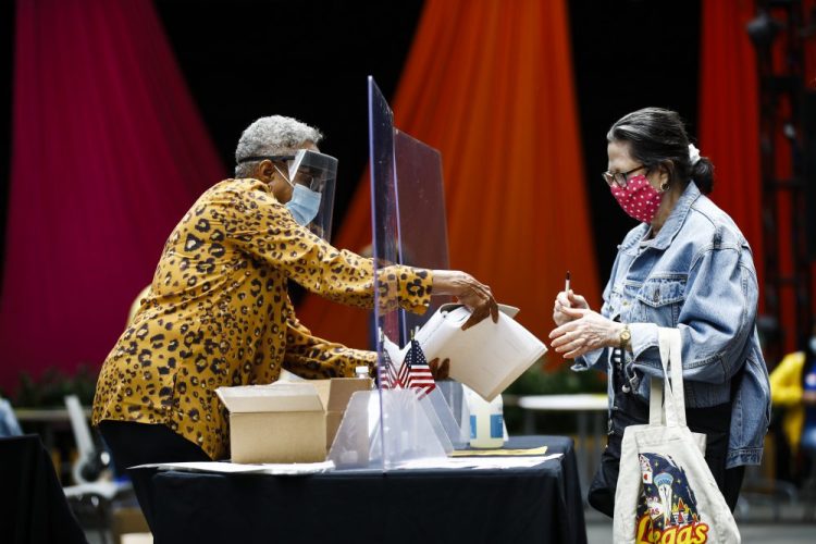 A voter, right, checks in with an election worker before casting her ballot in the Pennsylvania primary in Philadelphia on Tuesday.