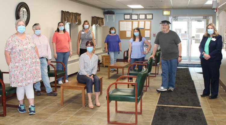 Kennebec Behavioral Health staff and clients utilize personal protective equipment and follow all CDC guidelines to continue to provide services. From left are Tammy Thayer, med clinic nurse; Melinda Morissette, PMH-NP; Ann McCormick, secretary; Dr. Janine Taylor, medical director, seated; Linmarie Goulette, practice administrator; Tina Raynes, medical practice manager; Amber Robillard, administrative assistant; Andy Bard, central registration; and Sharon Nadeau, med clinic nurse supervisor.