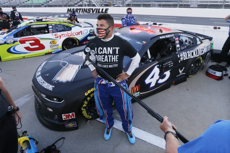 Driver Bubba Wallace is interviewed before a NASCAR Cup Series auto race on June 10 in Martinsville, Va. 