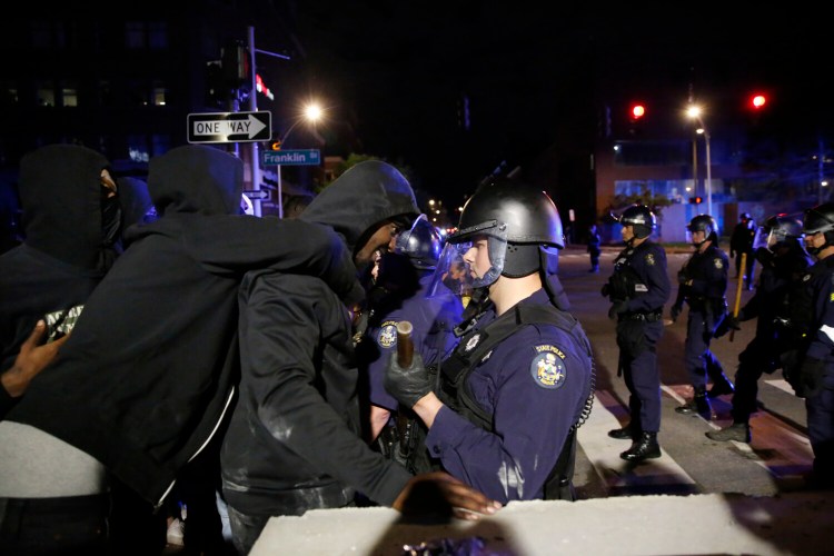Police clash with protesters at the intersection of Franklin and Middle Streets.