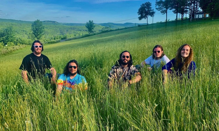From left to right: Henry Thomas (drums), Danny Circharo (lead guitar), Matt Arlowe (keyboards, vocals), Jack Davies (bass), Darby Rose-Lin Sabin (vocals, rhythm guitar)
