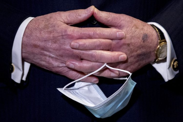 Senate Majority Leader Mitch McConnell, R-Ky., holds a face mask in his hands during a June 16 news conference on Capitol Hill in Washington. 
