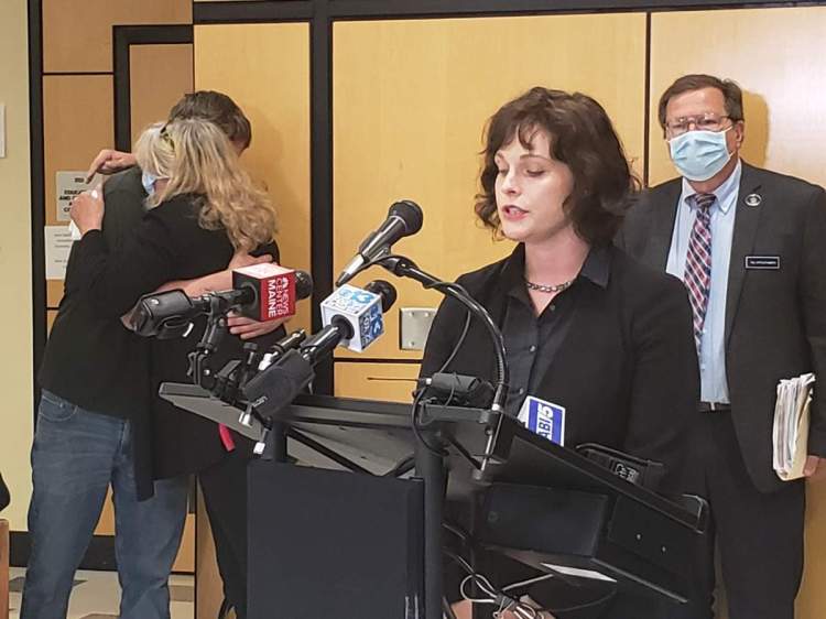 District Attorney Natasha Irving announces at a news conference in Augusta on Thursday that she plans to seek a murder indictment against former Waldoboro Police Officer Zachary Curtis for the 2007 shooting death of Gregori Jackson. Jackson's mother, Natalie Jackson, is being comforted in the background while Rep. Jeffrey Evangelos of Friendship listens at right.