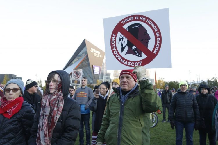 Native American leaders protest against the racist team name outside U.S. Bank Stadium before an NFL game between the Minnesota Vikings and Washington in Minneapolis. 