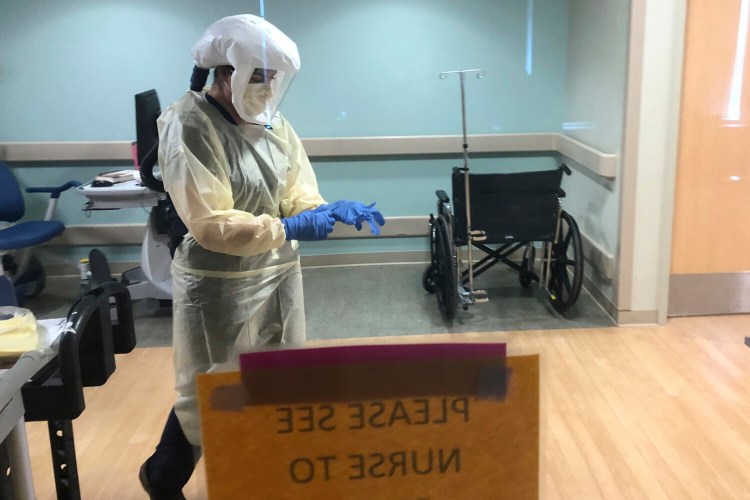 Dr. Ruba Nicola adjusts her personal protective equipment at the UPMC East hospital in Monroeville, Pa. The University of Pittsburgh Medical Center’s 40 hospitals in Pennsylvania, New York, Maryland and Ohio joined a study underway in the United Kingdom, Australia and New Zealand that randomly assigns patients to one of dozens of possible treatments and uses artificial intelligence to adapt treatments, based on the results.