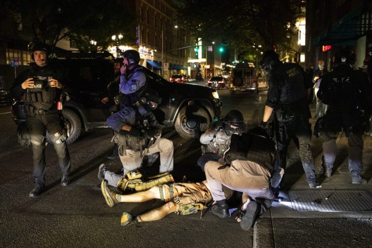 A man is treated after being shot Saturday,  in Portland, Ore. 


