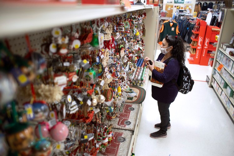 Elva Fuentes of Belvidere, Illinois, looks at holiday ornaments while shopping at Renys in Portland on Wednesday. Renys will continue its annual Early Bird sale, but this year will run it throughout that Saturday, Nov. 7.