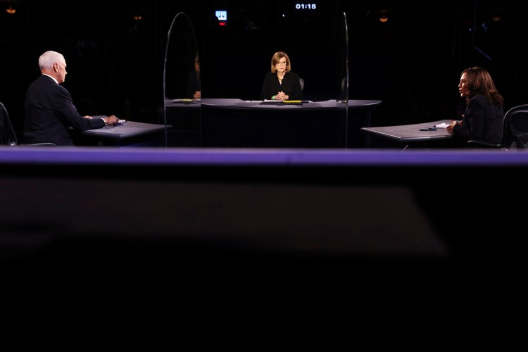 Vice President Mike Pence listens as Democratic vice presidential candidate Kamala Harris speaks during their debate Wednesday night in Salt Lake City.