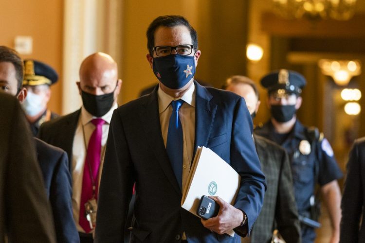 Treasury Secretary Steven Mnuchin walks from the office of Senate Majority Leader Sen. Mitch McConnell of Kentucky as he leaves the Capitol on Wednesday in Washington. Mnuchin is meeting with House Speaker Nancy Pelosi of California on Friday as they try to come up with a deal for more coronavirus aid.