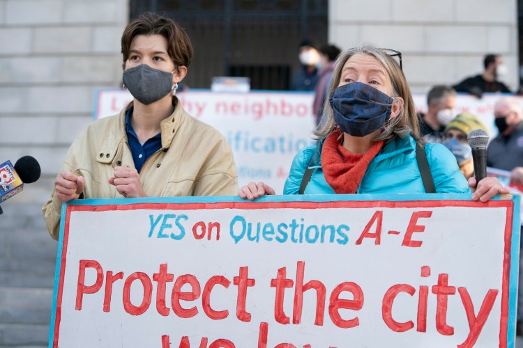 PORTLAND, ME - NOVEMBER 4: Em Burnett, left, and Kate Sykes, volunteers and organizers with the People First Portland campaign, address the media during a press conference outside of Portland City Hall on Wednesday, November 4, 2020. The five citizen referenda put on the ballot by People First Portland, which increase the minimum wage, impose rent control, strengthen a ban on facial surveillance technology, provide tenant protections and require businesses to pay time and a half for essential workers during declared emergencies, were approved by Portland voters. (Staff Photo by Gregory Rec/Staff Photographer)