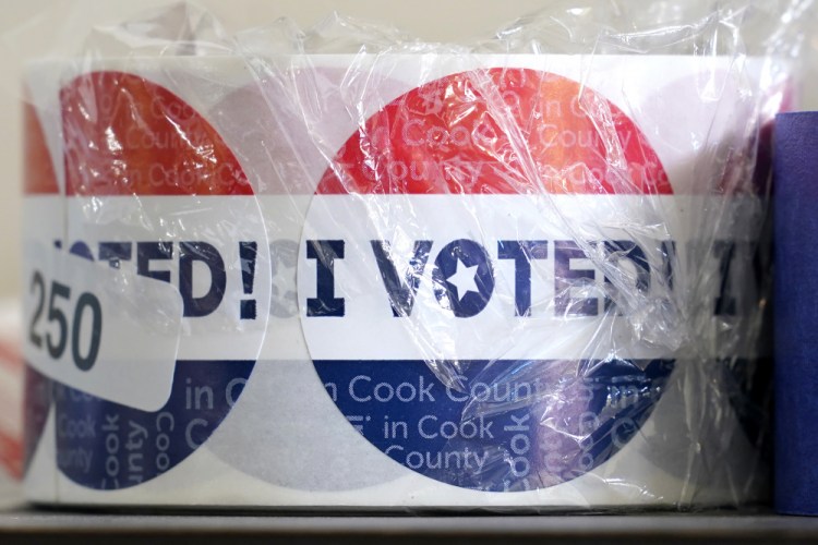 A roll of "I VOTED" stickers sit on a shelf as residents participate in early voting on Oct. 13 at a county courthouse in Maywood, Ill. 