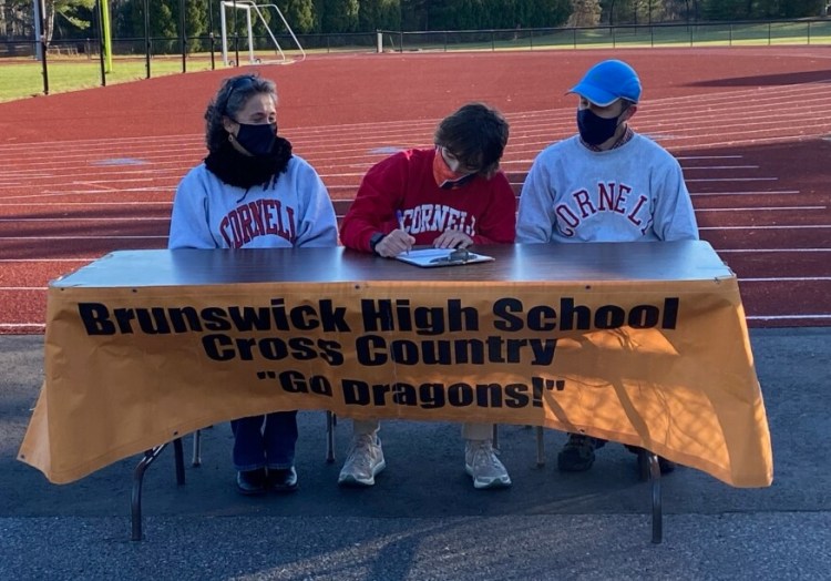 Tyler Patterson signs his National Letter of Intent to run at Cornell University as his parents watch on Tuesday at Brunswick High School