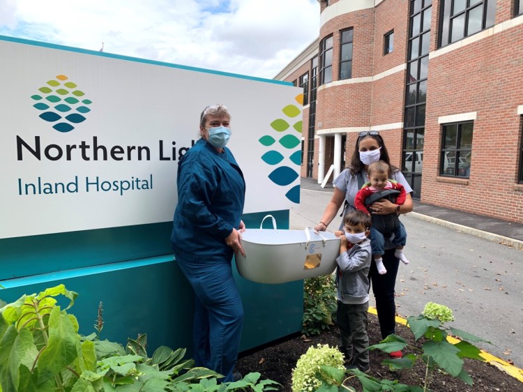 Courtney Cook, RN, left, director of Northern Light Birthing at Inland Hospital in Waterville, with Amie Marzen,  right, president of Madeline’s Mission with two of her children.